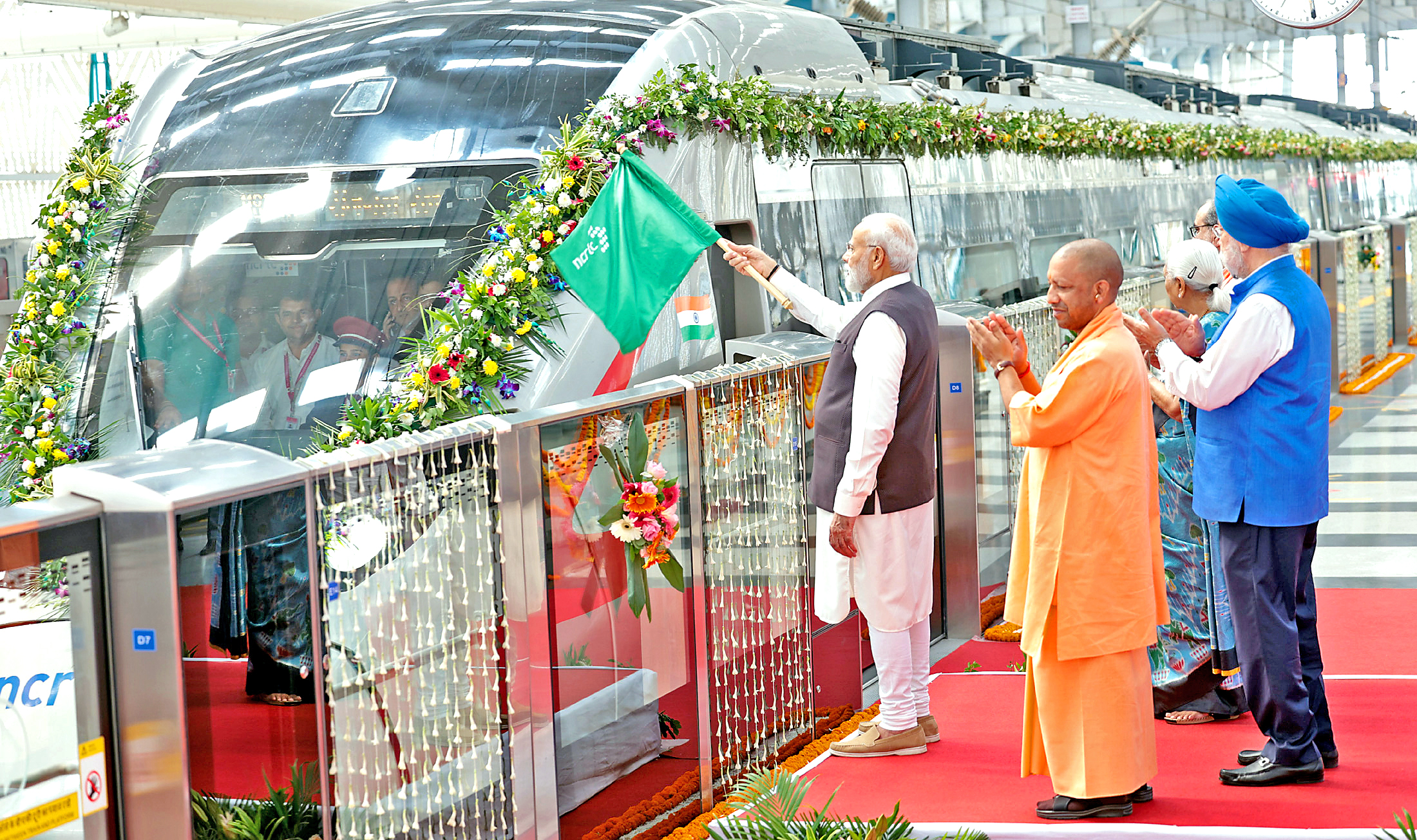 PM Modi flags off the RapidX train between Sahibabad and Duhai Depot, in Ghaziabad on Friday. Hardeep Singh Puri, Anandiben Patel and Yogi Adityanath are also seen.