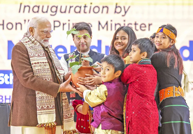 Kids present plant to PM Modi.