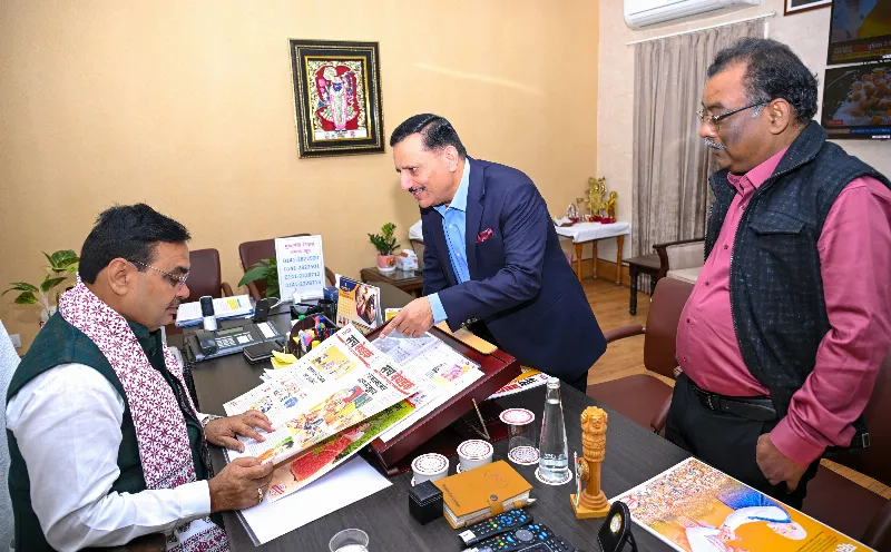 CM Bhajan Lal Sharma flips through the pages as Pawan Arora and Manoj Mathur look on