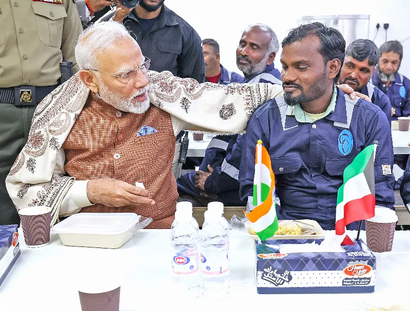 PM Modi shares a light moment with an Indian worker.