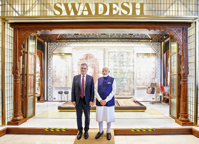 PM Narendra Modi visits a stall with UK PM Keir Starmer during an exhibition at the Global Fintech Fest 2025, at Jio World Centre.